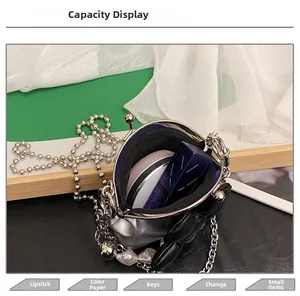 Mini crossbody bag interior showing storage for lipstick and makeup powder compact