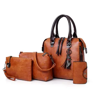 Brown four-piece handbag set with large tote and cat charm in textured faux leather