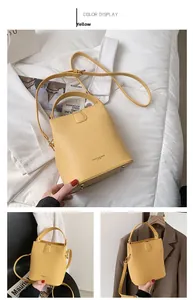 Bottom view of yellow bucket bag showing protective metal feet and smooth PU leather