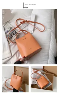 Detailed views of orange PU leather bucket bag with gold hardware and bottom protective studs