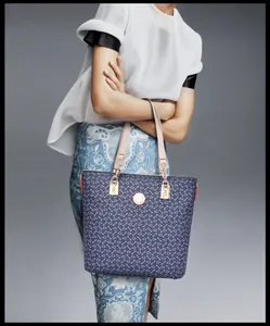 Navy tote bag with geometric print and leather handles shown on a model for daily use