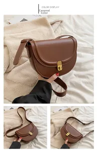 Detail of caramel faux leather saddle bag with matte finish and adjustable strap