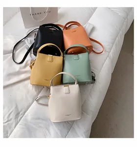 Detailed view of fashion bucket bags in five colors with adjustable shoulder straps