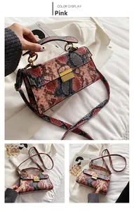 Detail view of pink snakeskin pattern square bag with gold lock and adjustable strap