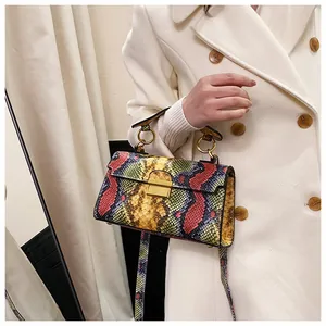 Detail of colorful snakeskin pattern small square bag with elegant golden metal lock