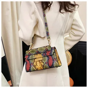 Close-up of vibrant multi-color snakeskin texture and gold metal clasp on small crossbody bag