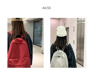 Detailed back view of spacious red and white canvas backpacks with wide shoulder straps