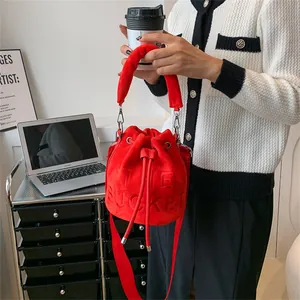 Chic red plush velvet bucket bag with embossed text and adjustable strap for women