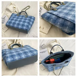 Detail of blue and white checkered tote bag with gold chain strap and large interior space