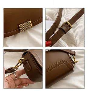 Detailed close-up of brown leather bag featuring golden metal hardware and fine stitching