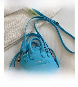 Detailed top view of light blue mini bag with golden hardware and drawstring lining