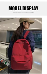 Model wearing a red large-capacity waterproof backpack in a minimalist style