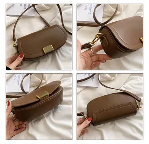 Detail view of brown saddle crossbody bag showing gold buckle and stitching texture