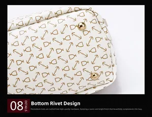 Macro shot of protective gold metal feet on white leather bag with gold anchor pattern