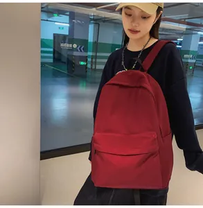 Detail of burgundy student backpack with large main compartment and front pocket