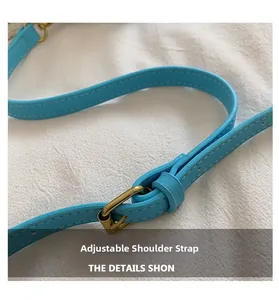 Close-up of light blue lychee leather adjustable shoulder strap with gold buckle