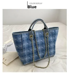 Blue denim tote bag with diamond texture, metallic chain strap and spacious interior