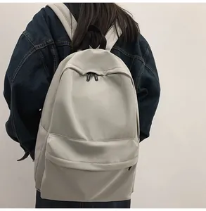 Side view of a student wearing a minimalist grey nylon backpack with wide shoulder straps