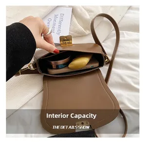 Internal capacity of brown vintage leather crossbody bag with items like phone and makeup