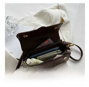 Detailed interior view of a dark brown handbag showing large capacity and magnetic closure