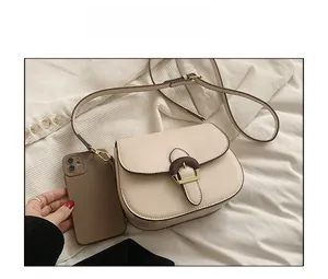 Detailed size reference for cream saddle bag with wood grain buckle and shoulder strap