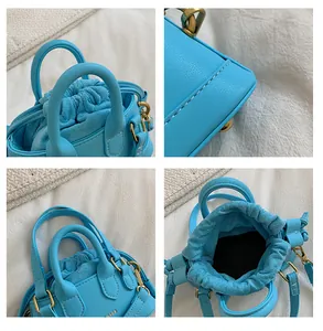 Macro details of light blue mini handbag showing stitching, drawstring and hardware