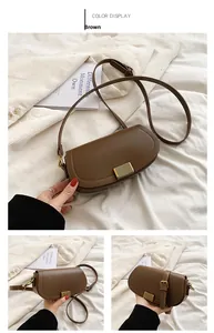 Brown saddle-shaped crossbody bag with gold metal buckle decoration and adjustable strap