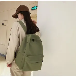 Side view of olive green durable nylon backpack showing main storage and side pockets