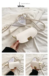 Close-up of white PU leather saddle bag featuring a refined gold striped metal lock buckle