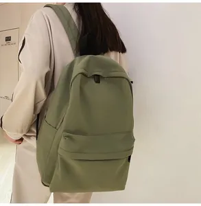 Side view of olive green school backpack on a model showing large capacity and straps
