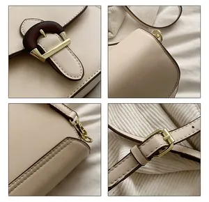Detailed macro view of wood-grain buckle and golden hardware on a cream saddle bag