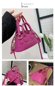 Detailed view of purple mini crossbody bag with drawstring closure and golden logo