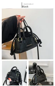 Detailed close-up of a mini black tote bag featuring gold hardware and a drawstring liner