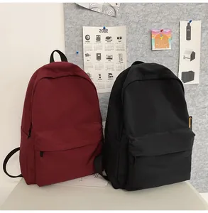 Waterproof nylon school backpacks in burgundy and black with spacious zip pockets