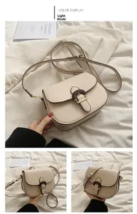 Detail view of light khaki saddle bag with wooden D-ring buckle and PU leather texture
