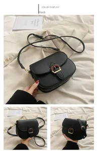 Detail of black PU leather saddle bag featuring a unique wood grain horseshoe buckle