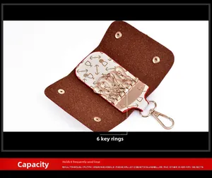 Detailed interior of the brown PU leather key wallet showing six gold metal key hooks
