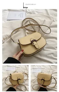 Detail view of yellow saddle bag with wood-texture buckle and adjustable strap