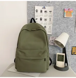 Olive green canvas backpack featuring a minimalist dual-zipper compartment design
