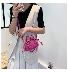 Close-up of rose red mini crossbody bag with drawstring lining and fashion logo