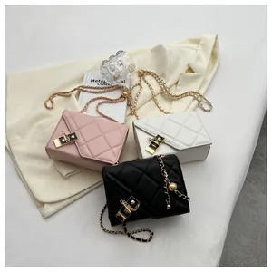 Detail of quilted leather chain bags in pink, white and black with metal locks