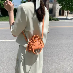 Mini orange drawstring crossbody bag for women with fashion lettering and top handles