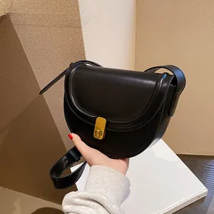 Classic black PU leather saddle bag with gold metal lock and adjustable shoulder strap