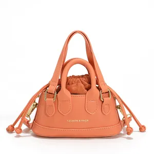 Mini coral drawstring crossbody bag with top handles and fashion text on white background