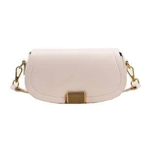 Minimalist beige half-moon crossbody bag with gold metal lock and leather strap