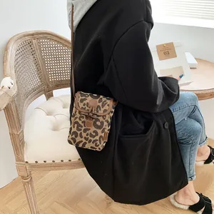 Leopard print crossbody mini phone bag with canvas material and wooden horn buckle detail