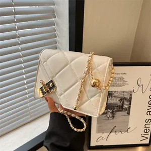 White quilted crossbody bag with golden chain strap and adjustable ball lock