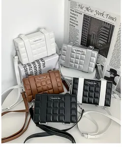 Close-up of quilted pattern and buckle details on several colorful mini crossbody bags