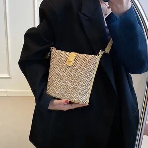 Women summer straw crossbody bucket bag with yellow leather trim and thin strap