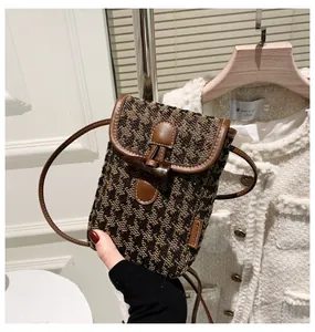 Brown houndstooth crossbody phone bag with vintage toggle closure and leather trim